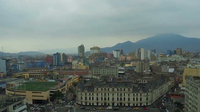 Lima Peru Aerial v55 Flying low over park plaza and traffic panning with cityscape views.