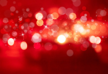 Red sparkles glitter and rays lights bokeh abstract holiday background/texture.