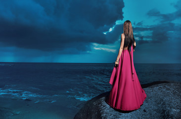 Pretty lady looking at the calm occean