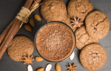 Chocolate smoothie with bananas and cookies on the dark wooden background