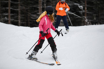 Naklejka premium young girl with ski in the snow forest.