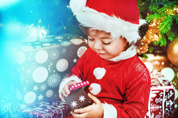 Little santa kid checking the gift