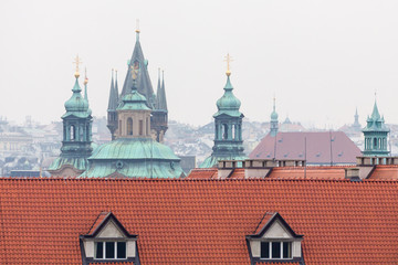 Fototapeta na wymiar View on the red roofs and cathedral towers in Prague.