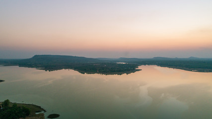 arial View of country with mountain at twilight sky. - drone camera.
Beautiful lake against mountain background.