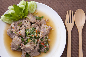 Closeup pork stir fried with basil leaves in white dish