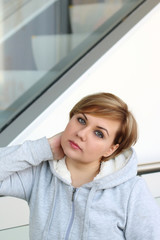 Beautiful young plump woman with sadness and melancholy looking directly into the camera by tilting the head to one side