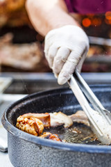 Roasting pork in a pan with splashes of fat