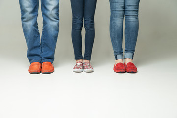  barefoot  legs of mother, father and little child wearing  jeans 