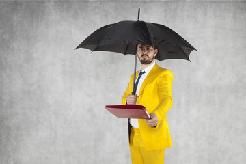businessman under the umbrella protects data