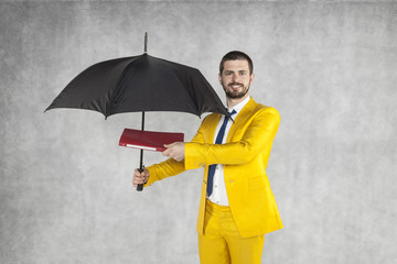 businessman with briefcase protects data under the umbrella