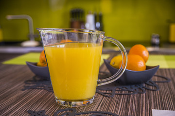 Orange juice in pitcher and oranges. healthy eating, food, dieting and vegetarian concept . orange juice on wooden table