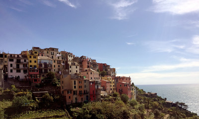 Fototapeta na wymiar Amazing landscape view of Corniglia, houses, sky, horizon and sea.