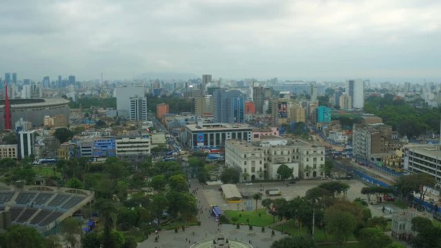 Lima Peru Aerial v60 Flying low over Park of the Exposition panning with cityscape views.