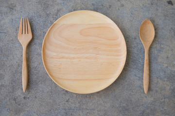 Top view of wooden plate fork spoon