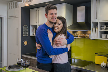 Couple sharing affectionate moment. Happy couple drinking vine and spending time together at home. Couple in love hugging