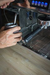 Barista steaming milk at Espresso bar with space for copy