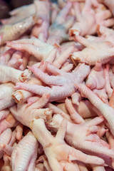 Fresh and raw chicken feet in market for cooking ingredient