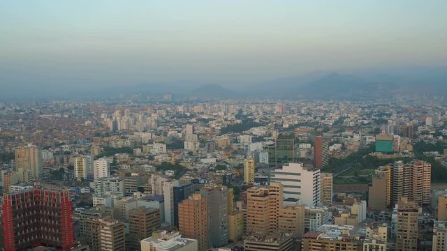 Lima Peru Aerial v64 Flying over Miraflores panning with cityscape views at sunset.