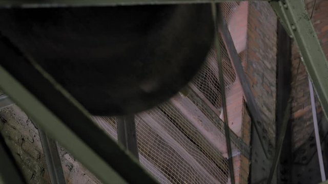In an Old Church at the Belfry a Bell is Ringing in Slow Motion