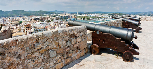 Dalt Vila castle wall with cannons. Ibiza historical fortress. Famous place of interest.