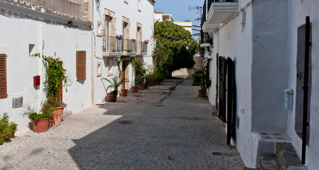 Old Ibiza street. Touristic path route. Architecture of Balearic Islands. Siesta time.