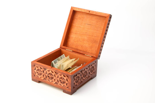 carved wooden box of lime with banknotes isolated on a white background