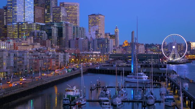 Seattle, WA - January 30, 2017. The light of downtown Seattle at night. Port of Seattle. Skyscrapers on a background of blue sky. Pier 66. City landscape video. 4K, 3840*2160, high bit rate, UHD