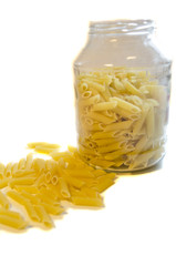 Raw pasta in glass pot isolated on white background