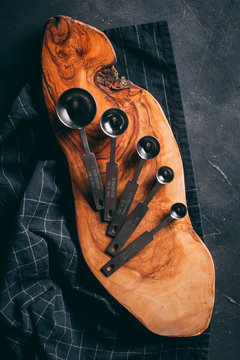 Measuring spoons on wooden cutting board
