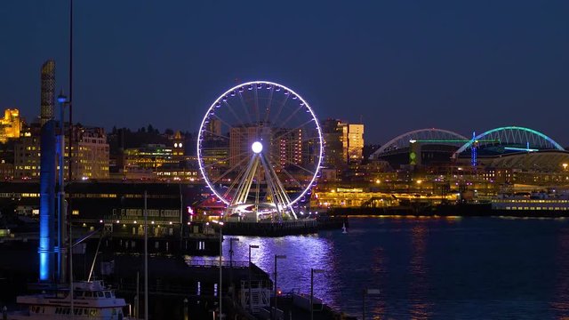 Seattle, WA - January 30, 2017. The light of downtown Seattle at night. Port of Seattle. Skyscrapers on a background of blue sky. Pier 66. City landscape video. 4K, 3840*2160, high bit rate, UHD