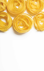 Background of spaghetti on white background. Italian pasta. Horizontal shoot. Copy space.