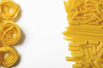 Background of various types of pasta with white space in the middle. Copy space. Horizontal shoot.