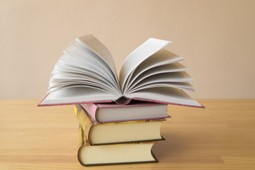 Vintage old books on wooden deck table and grunge background
