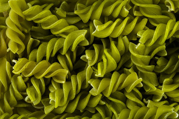 Fototapeta premium Background of colorful pasta texture close-up. Assortment of colorful macaroni. italian pasta. Variety of types and shapes of dry Italian pasta. Full background of dry uncooked macaroni.