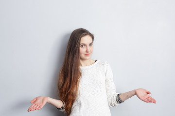 The girl in disbelief makes a helpless gesture. Do not understand what to choose