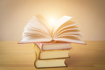 Vintage old books on wooden deck table and grunge background