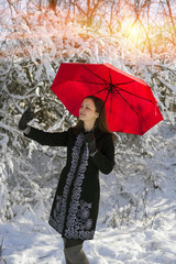 Girl among the snow in the winter