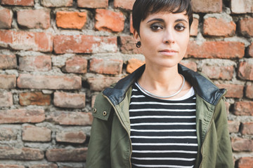 Portrait of young beautiful caucasian short hair woman looking in camera serious - pensive, thoughtful, melnacholic concept