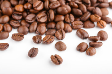 roasted coffee beans isolated in white background. Roasted coffee beans background close up. Coffee beans pile from top on white background with copy space for text. Good morning.