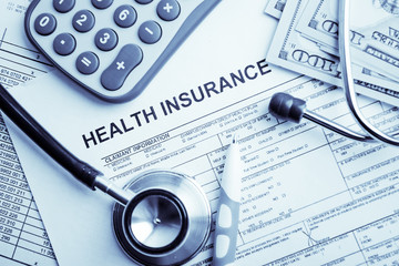 Health insurance application form with banknote and stethoscope concept for life planning