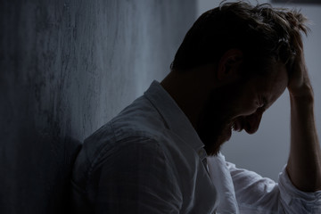 Man holding hand on head