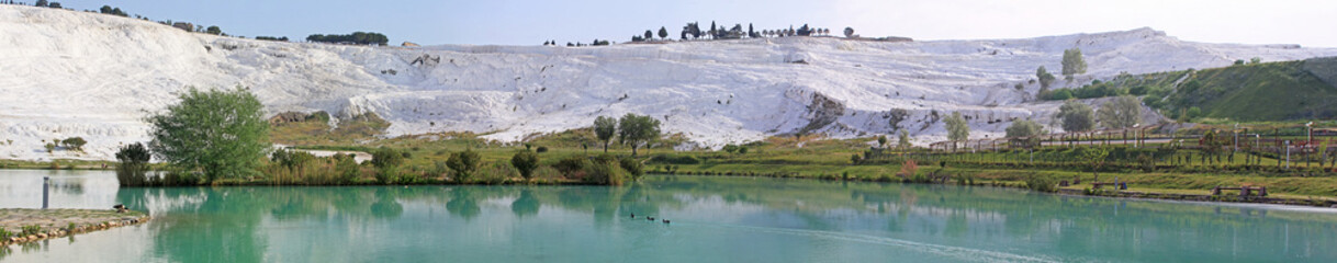 Panorama of lake and calcified limestone terraces, Pamukkale, Turkey
