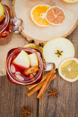 Mulled wine in glass mug   with spices and citrus fruit