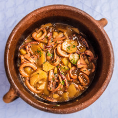 Crock with seafood octopus and potatoes