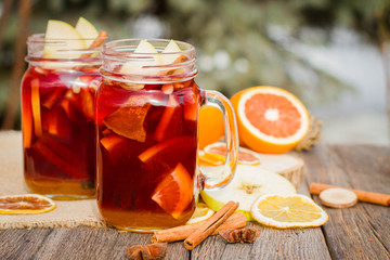 Mulled wine in glass mug   with spices and citrus fruit