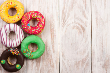 glazed donuts on a white wooden background with copy space for your text. Top view
