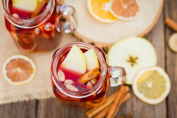 Mulled wine in glass mug   with spices and citrus fruit