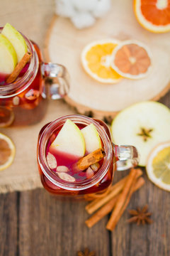 Mulled wine in glass mug   with spices and citrus fruit