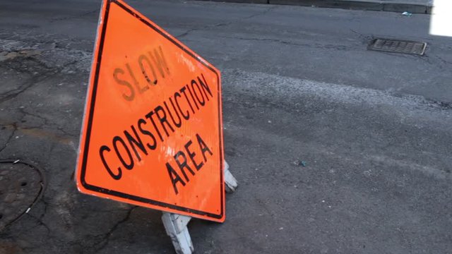 Slow Construction Area Sign on street in city