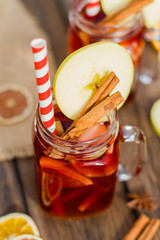 Mulled wine in glass mug   with spices and citrus fruit